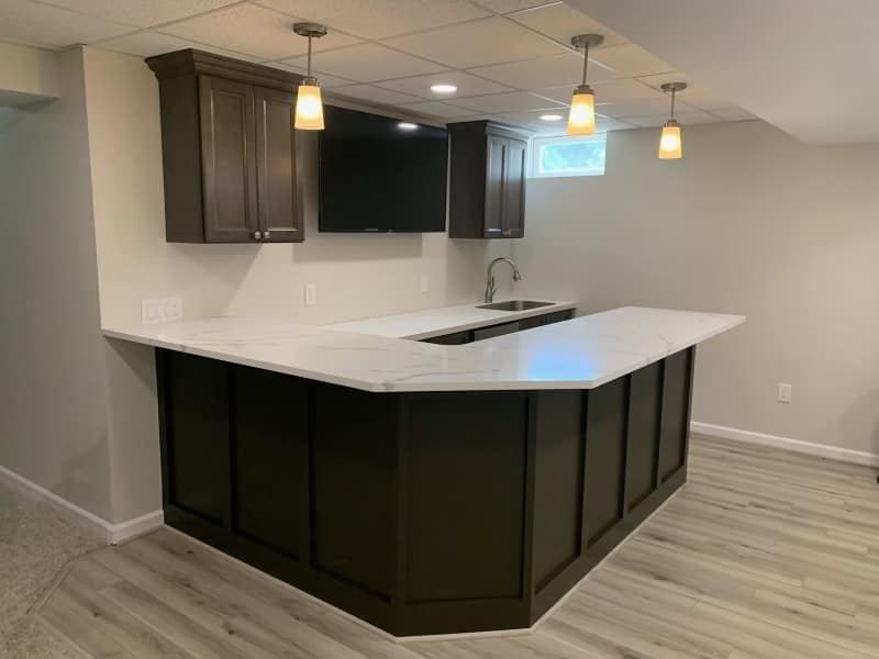A bathroom with a sink , mirror , and walk in shower.