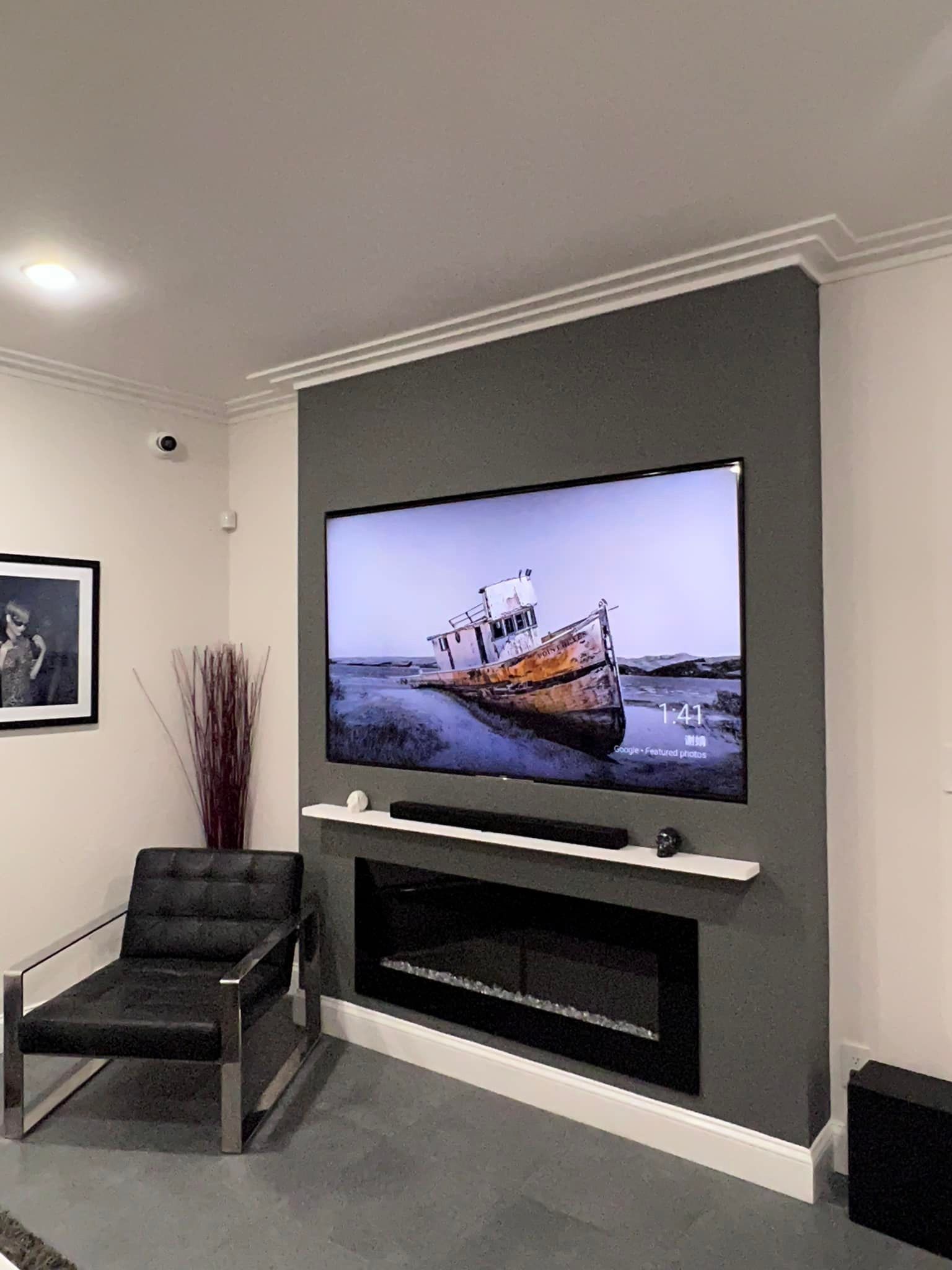 A living room with a large flat screen tv on the wall