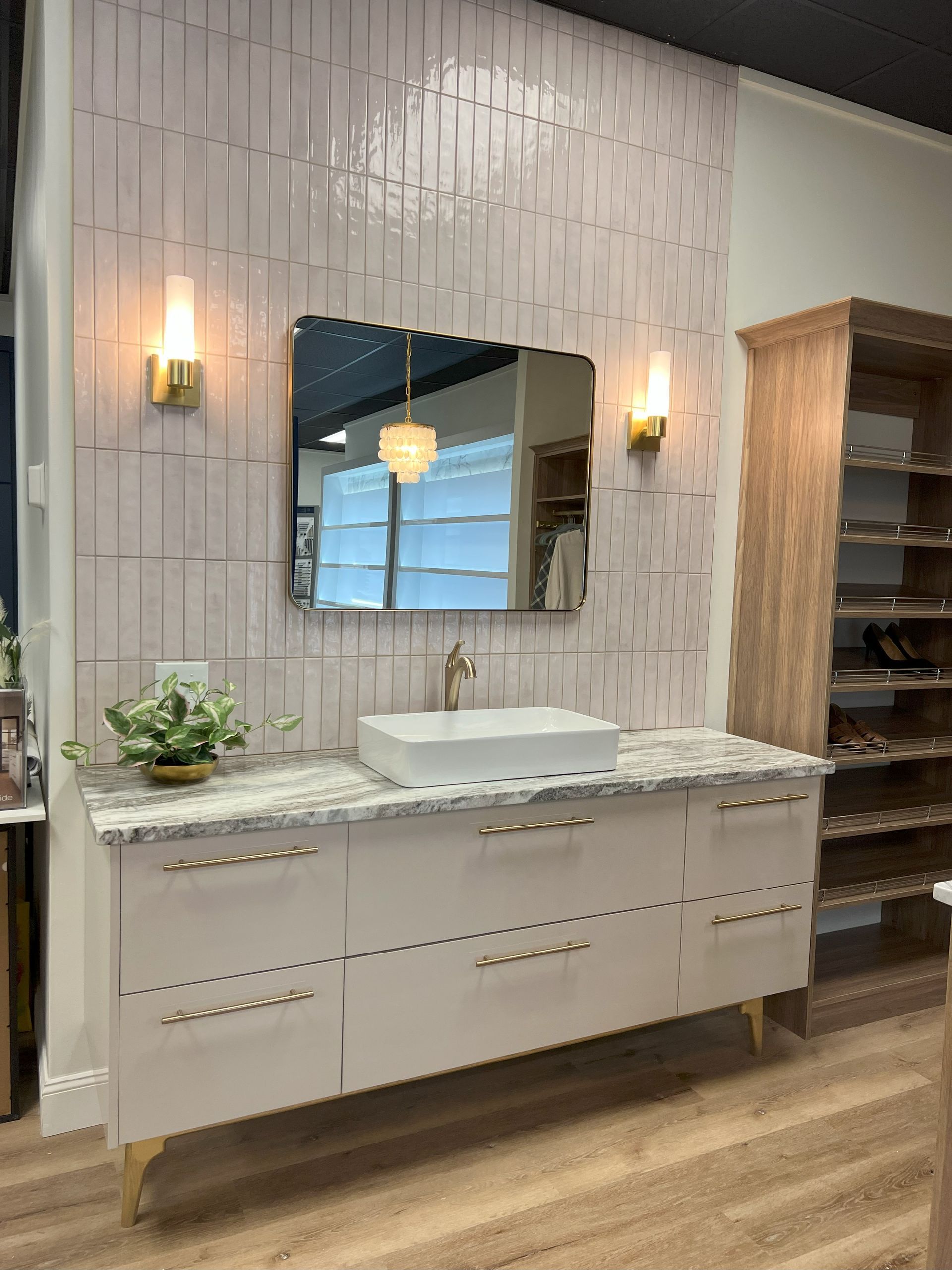 A bathroom with a sink , mirror , and cabinets.