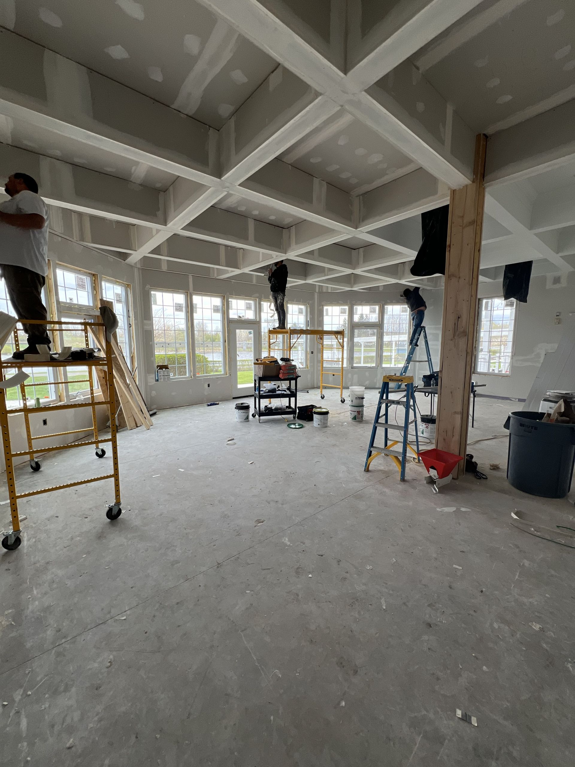 A set of stairs with black steps and a white railing leading up to a door.