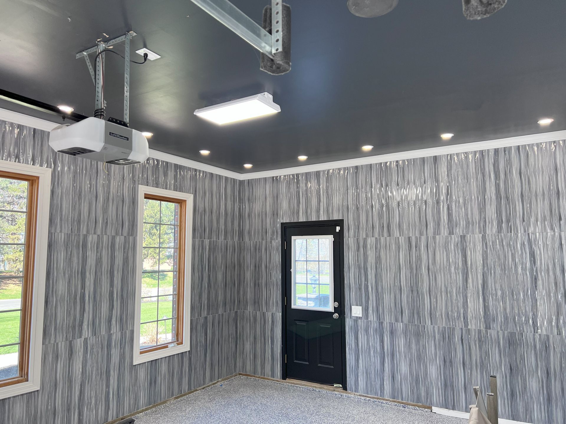 An empty room with hardwood floors and two windows.