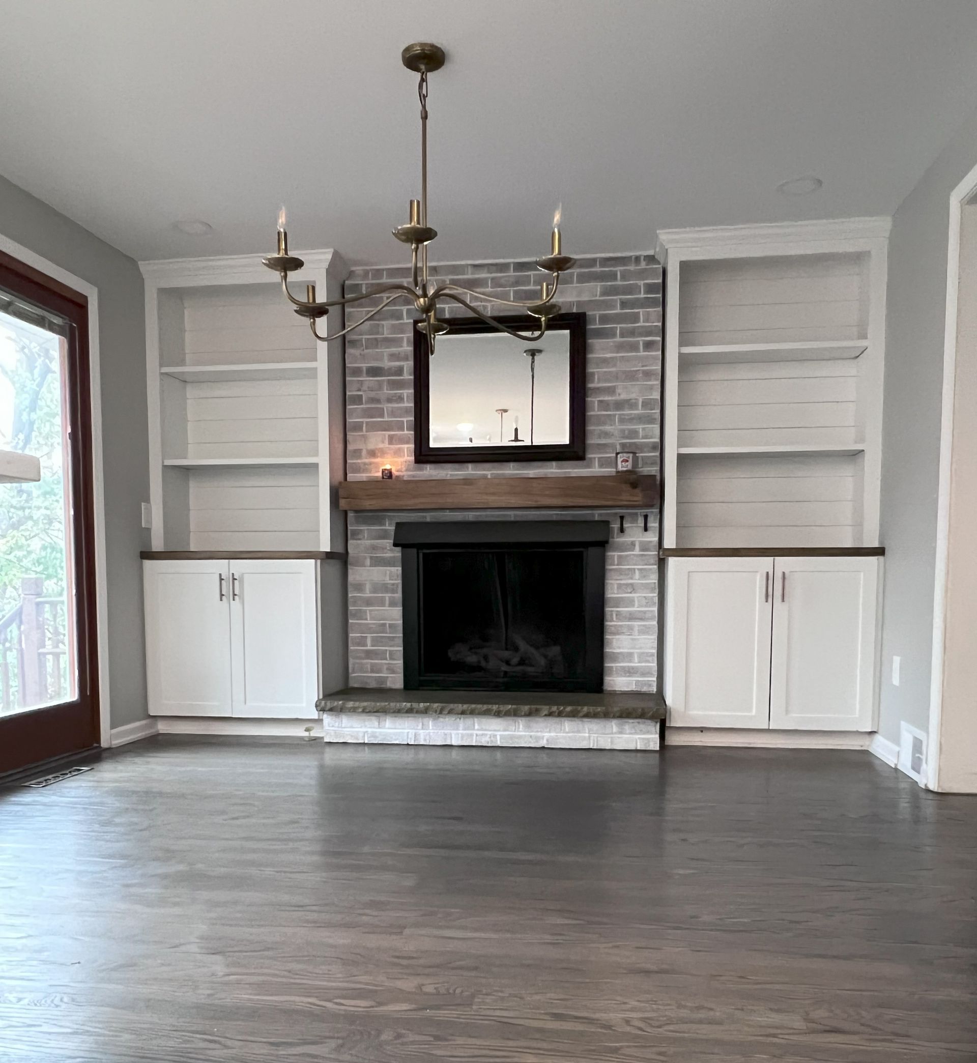 A bathroom with a sink , mirror , and walk in shower.