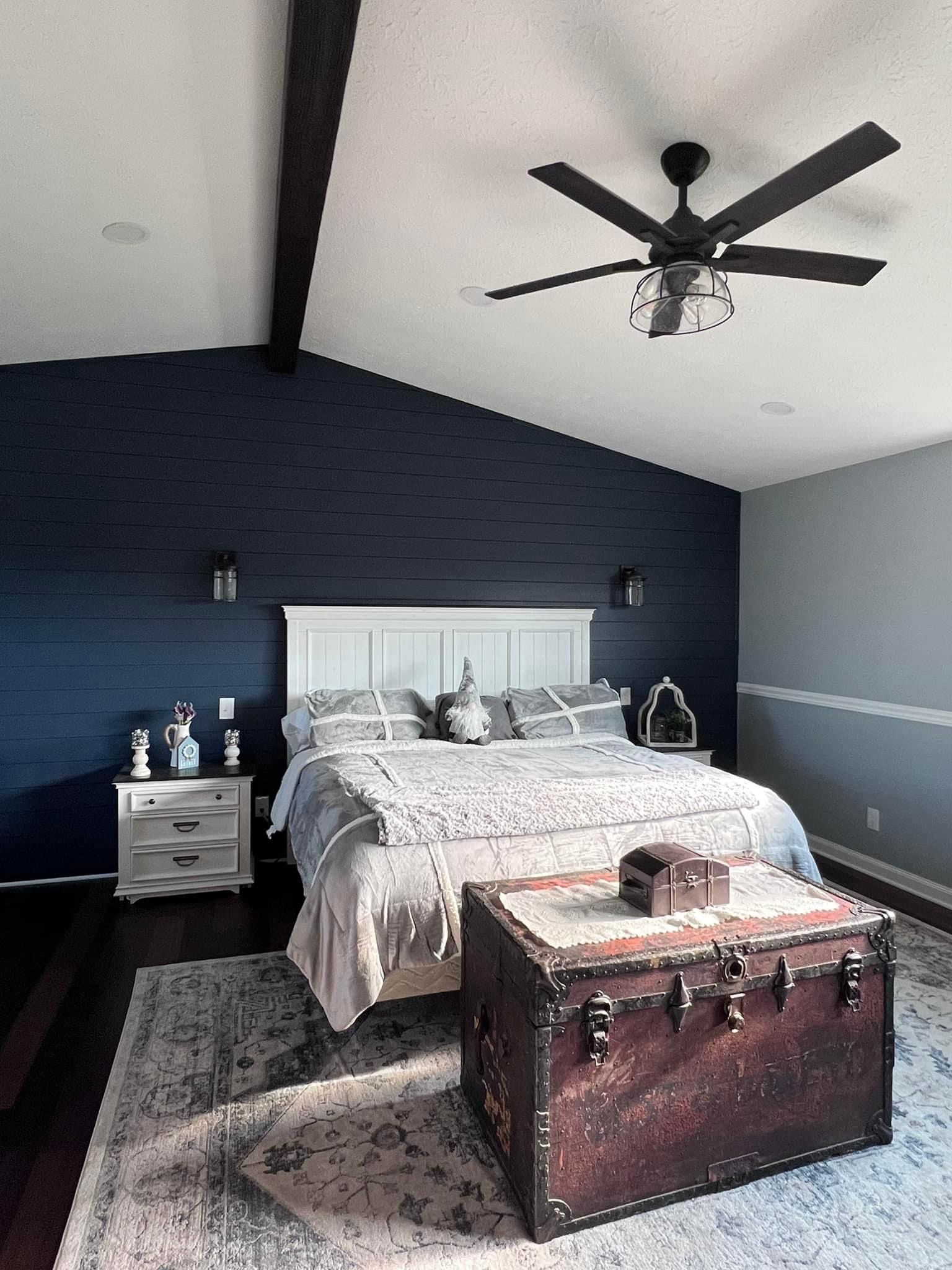 A living room with a couch , table , chair and french doors.