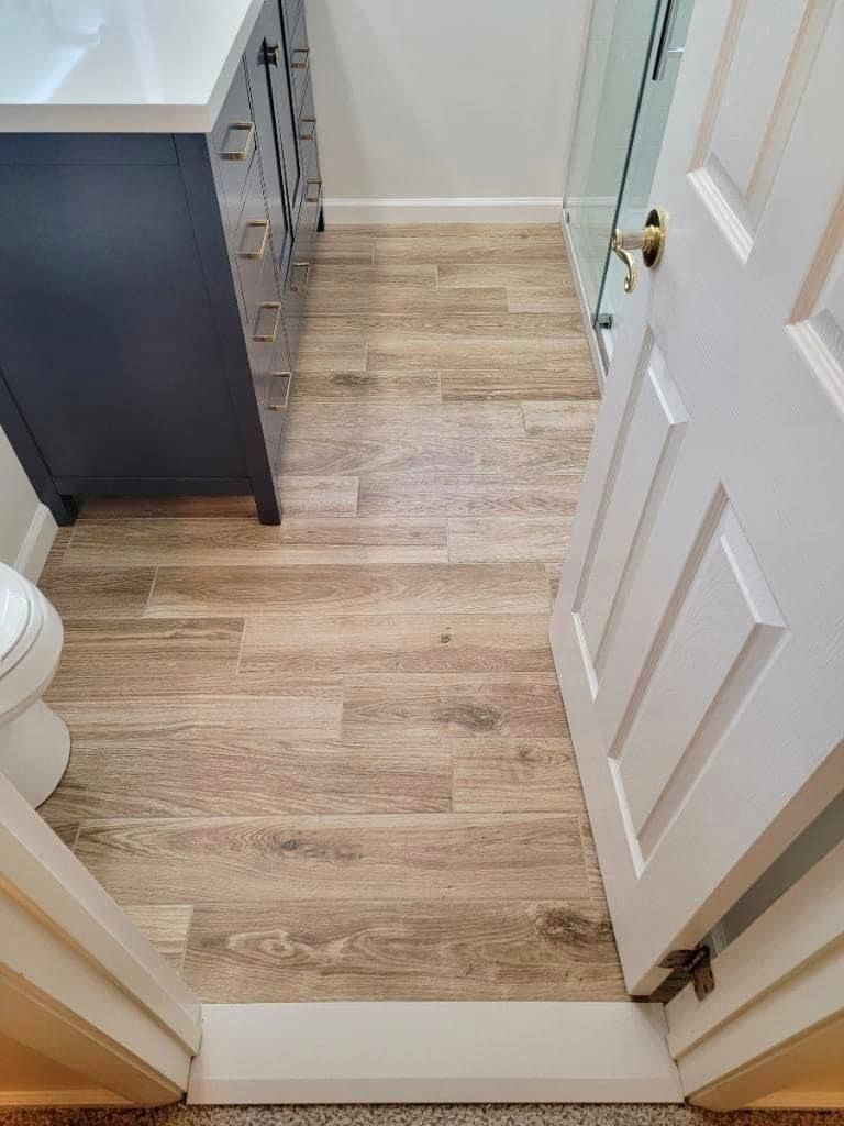 A living room with a couch , table , chair and french doors.