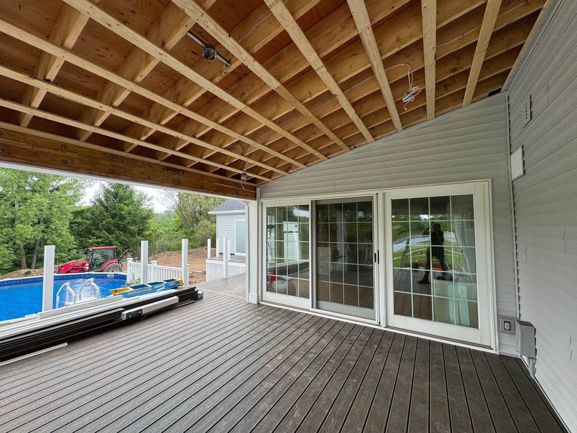 A kitchen with white cabinets , a large island , and stools.