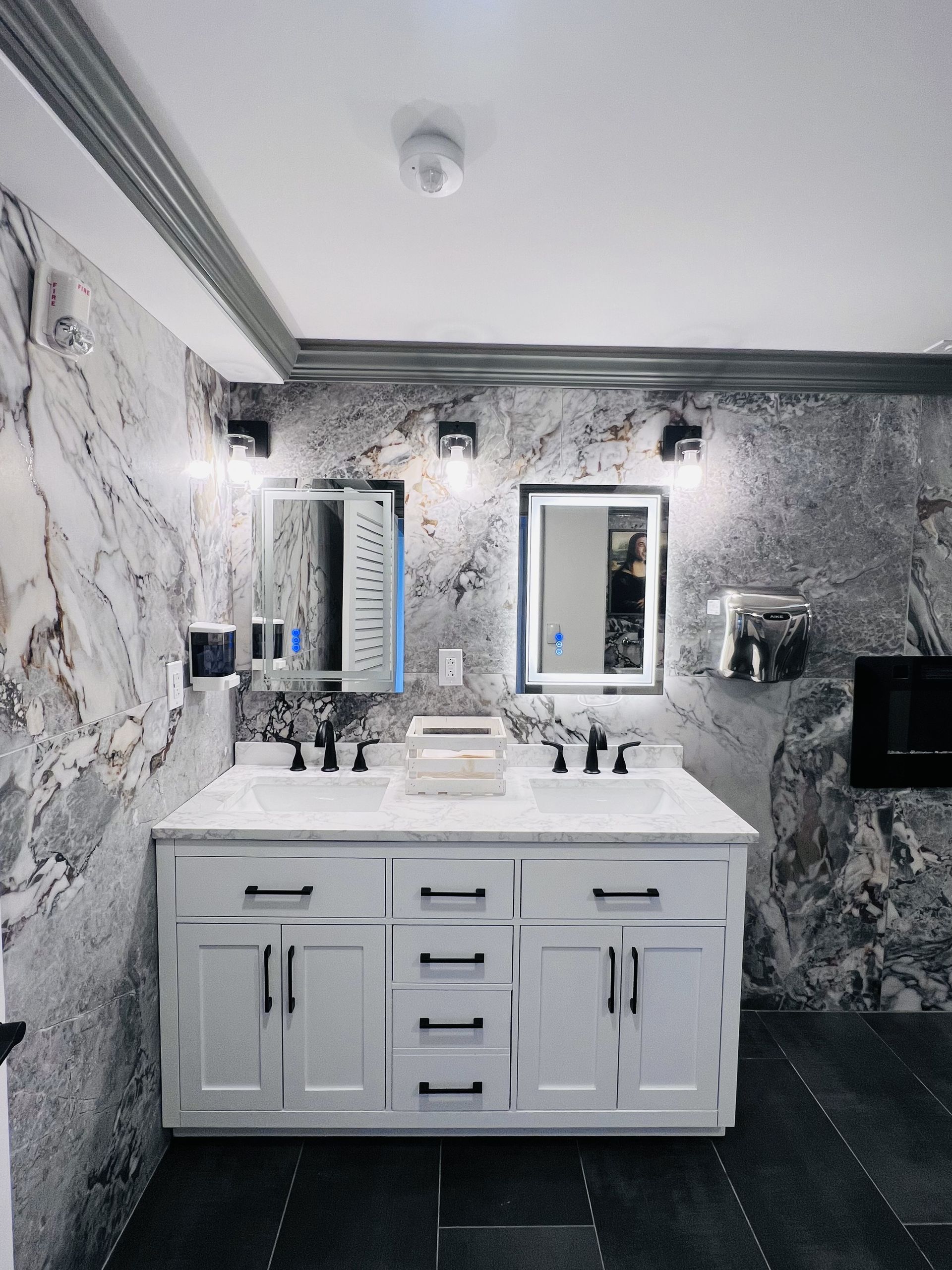 A bathroom with two sinks and two mirrors
