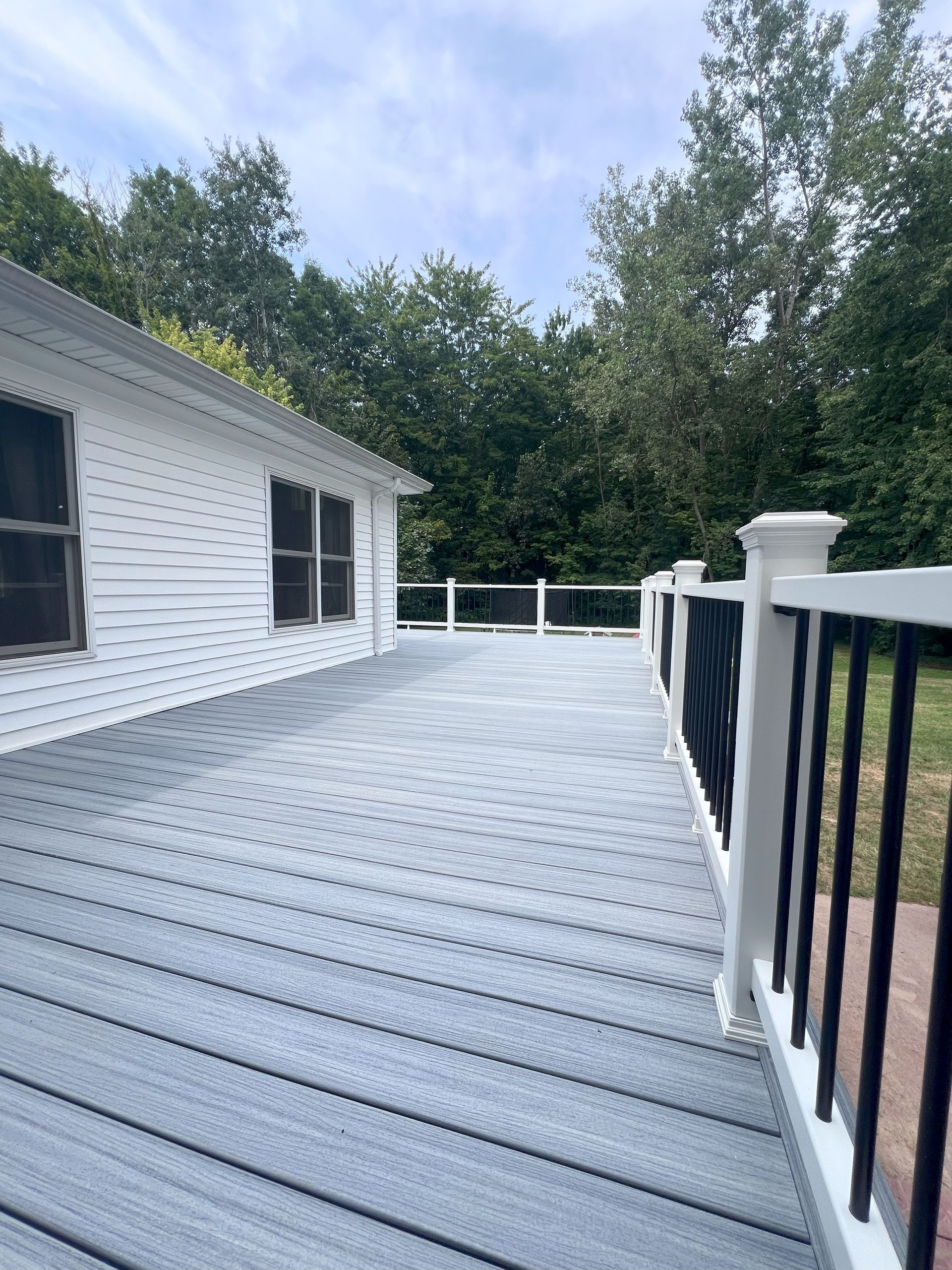A living room with a dining table and chairs and a kitchen.