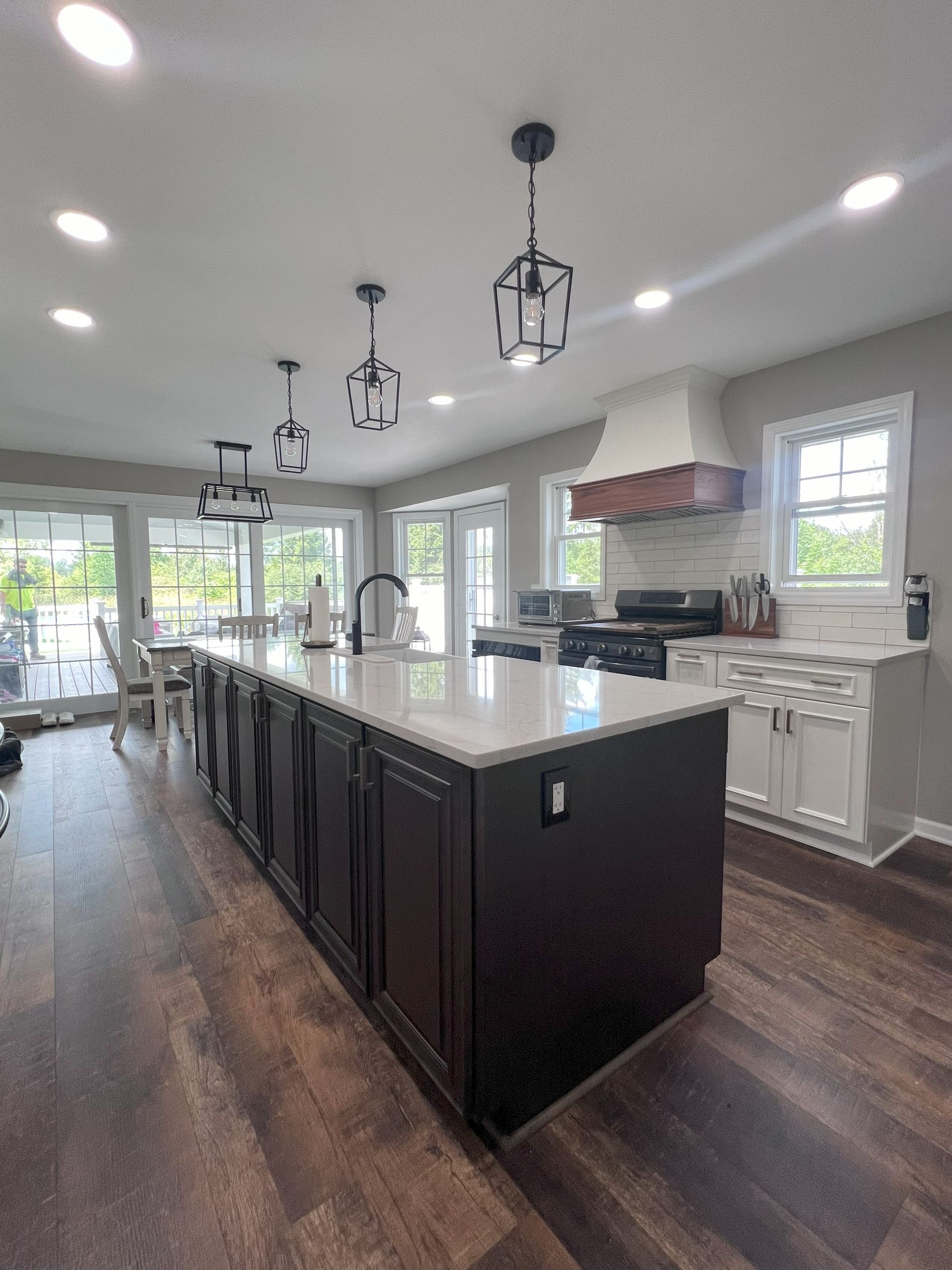 A living room with a couch , coffee table , fireplace and a painting on the wall.