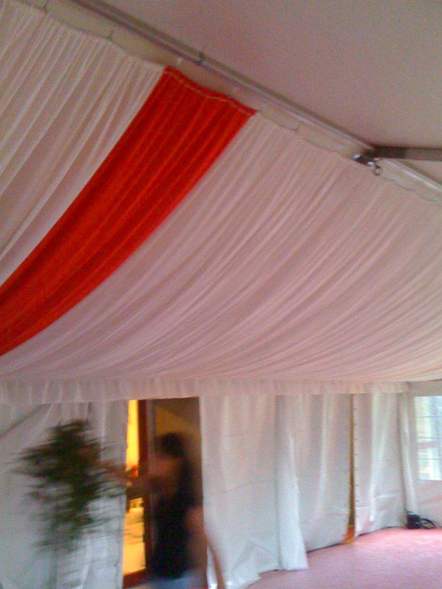 White and red fabrics under a tent