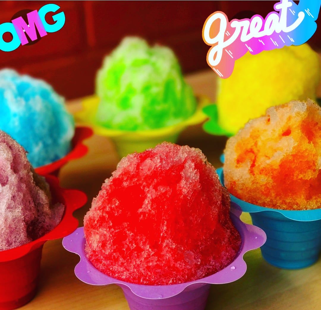 Shave Ice Hawaii local food woman eating hawaiian shaved ice cream treat in Honolulu Waikiki beach, Hawaii , USA.