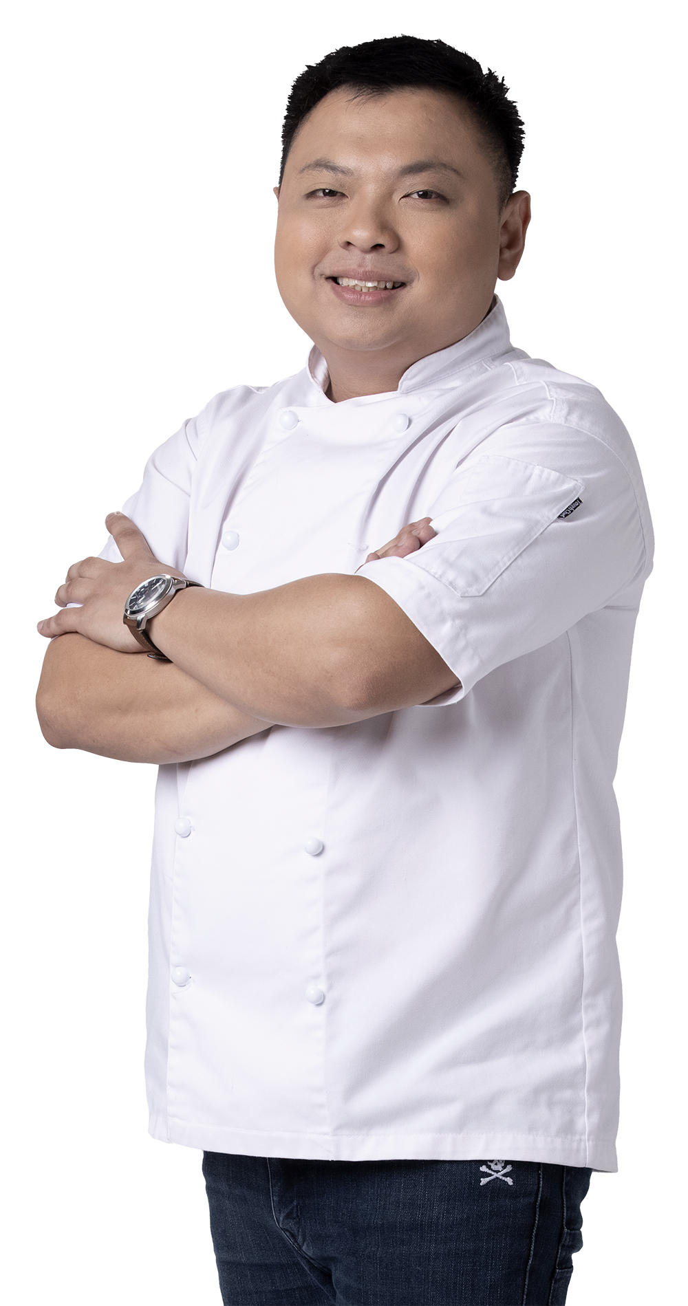 Chef, arms crossed, wearing white chef's coat, smiling.