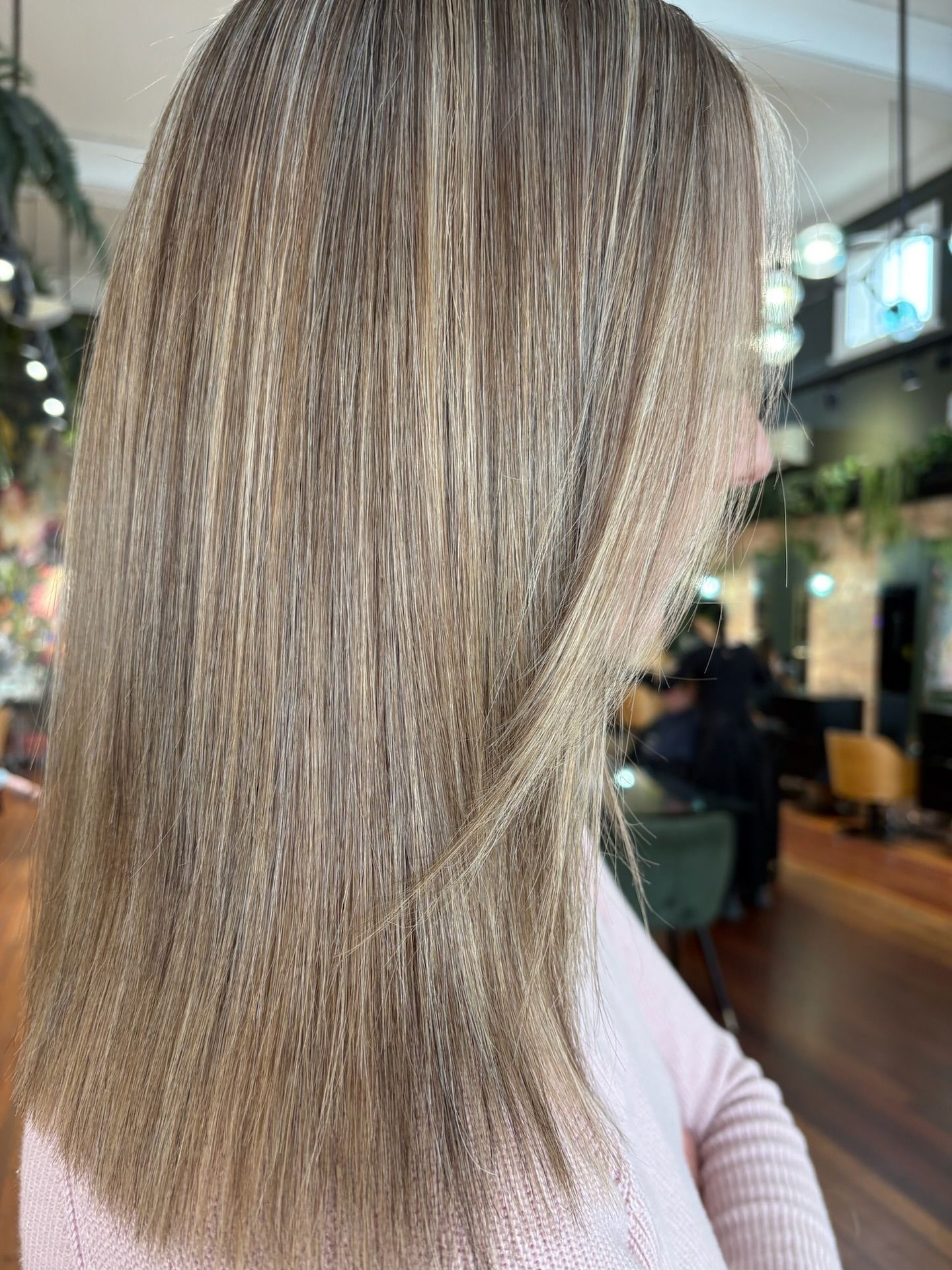 Woman with blonde and brown crimped hair, wearing a pink top, in a salon. — Air Hair Studio in Toowoomba City, QLD