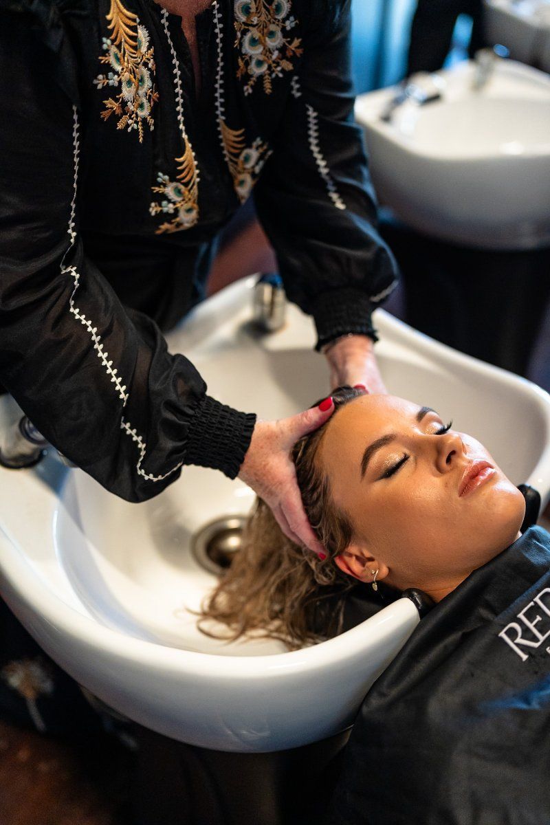 A Woman is Getting Her Hair Washed in a Sink at a Salon  — Air Hair Studio in Toowoomba City, QLD