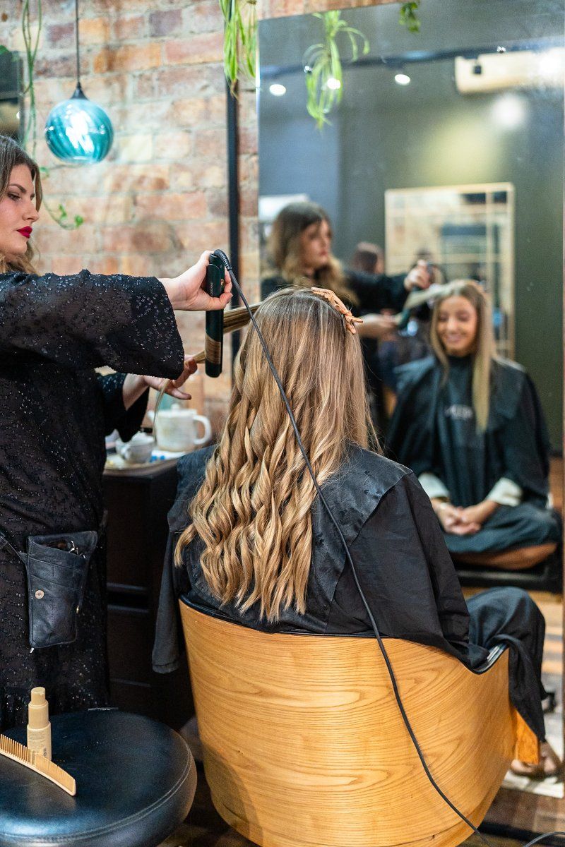 A Woman is Getting Her Hair Blow Dried in a Salon  — Air Hair Studio in Toowoomba City, QLD