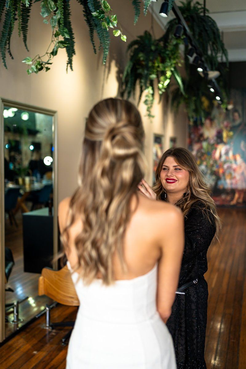 A Woman is Getting Her Hair Blow Dried in a Salon — Air Hair Studio in Toowoomba City, QLD