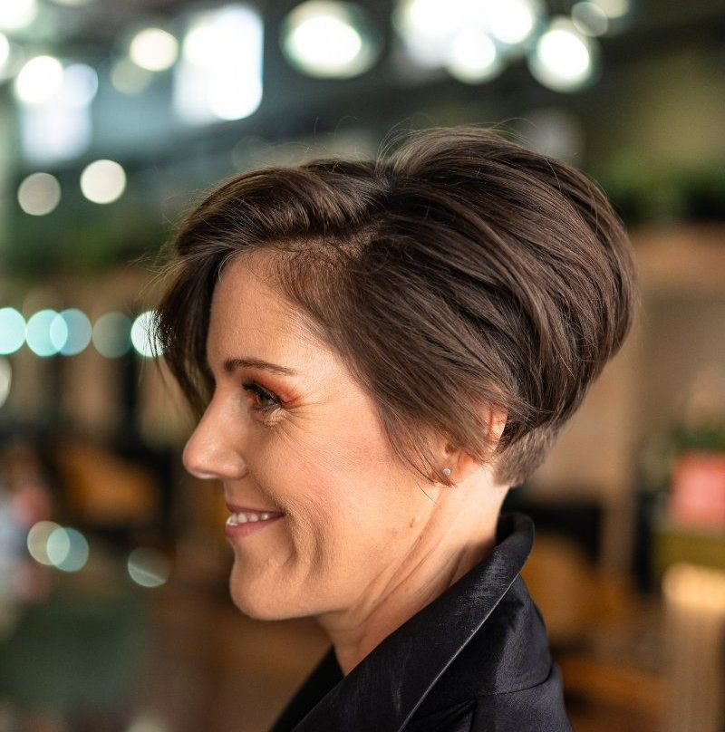 A Woman With Short Hair is Smiling and Wearing a Black Jacket — Air Hair Studio in Toowoomba City, QLD