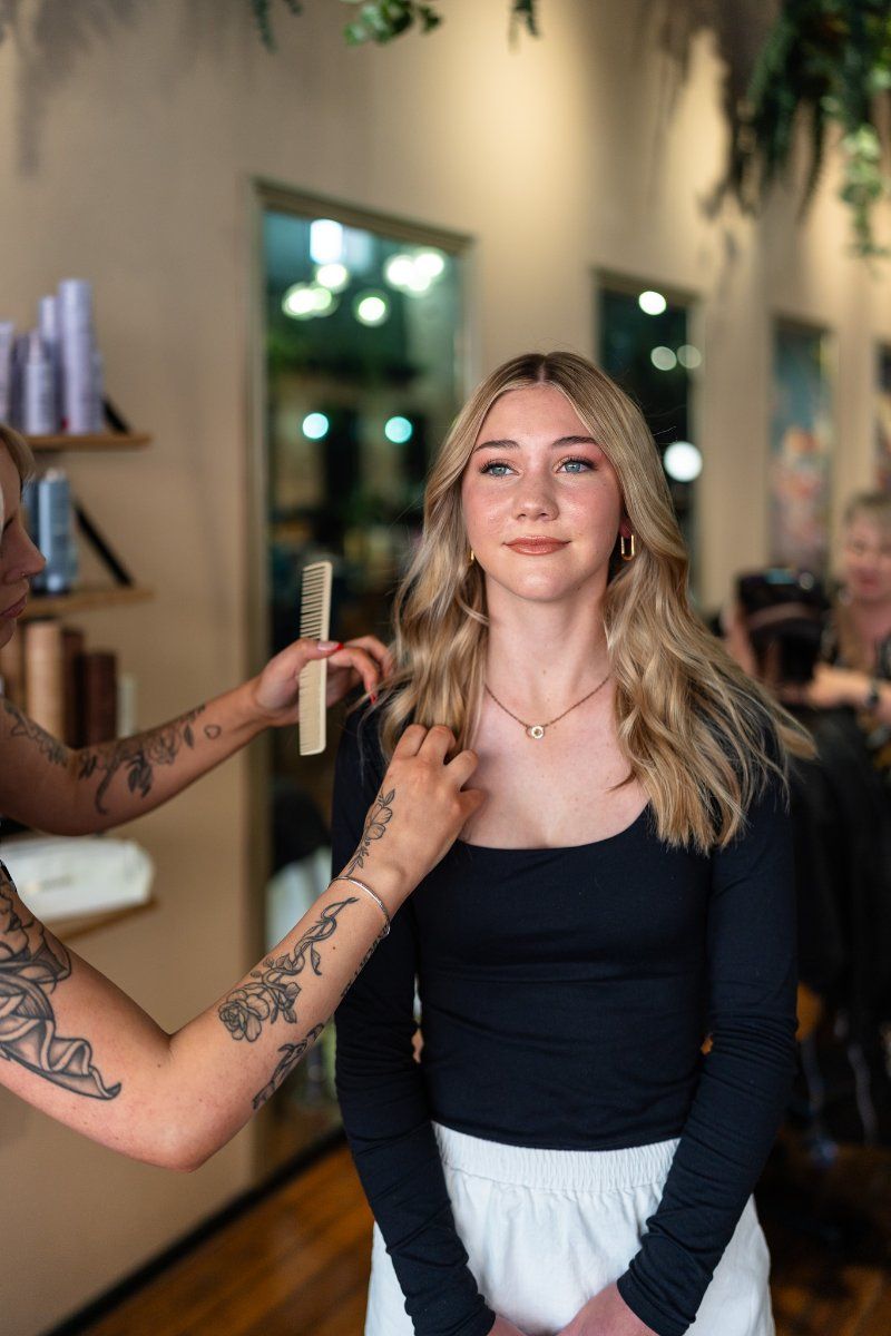 A Woman is Getting Her Hair Done by a Hairdresser in a Salon — Air Hair Studio in Toowoomba City, QLD