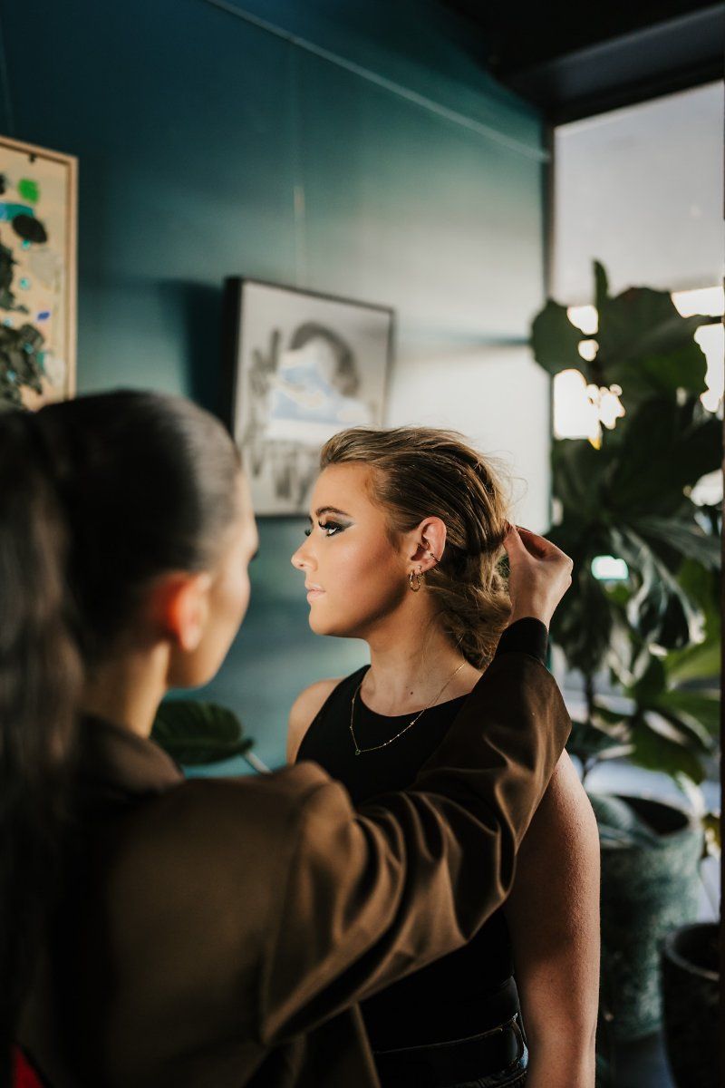 A Woman is Getting Her Hair Done by a Hairdresser in a Room — Air Hair Studio in Toowoomba City, QLD