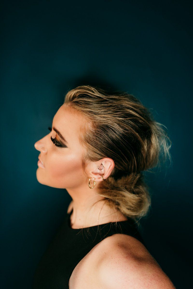 A Close Up of a Woman's Face With a Blue Background — Air Hair Studio in Toowoomba City, QLD