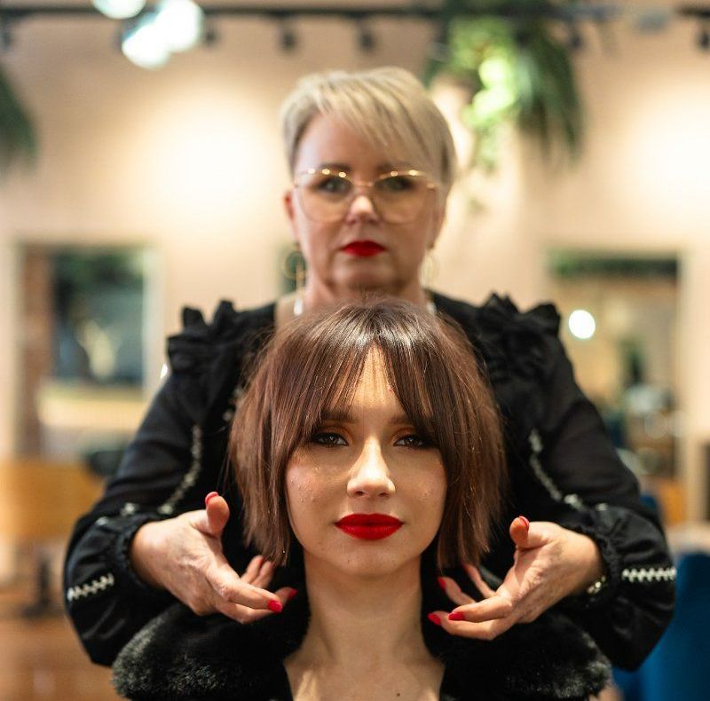 A Woman With Red Lipstick is Getting Her Hair Done by Another Woman — Air Hair Studio in Toowoomba City, QLD