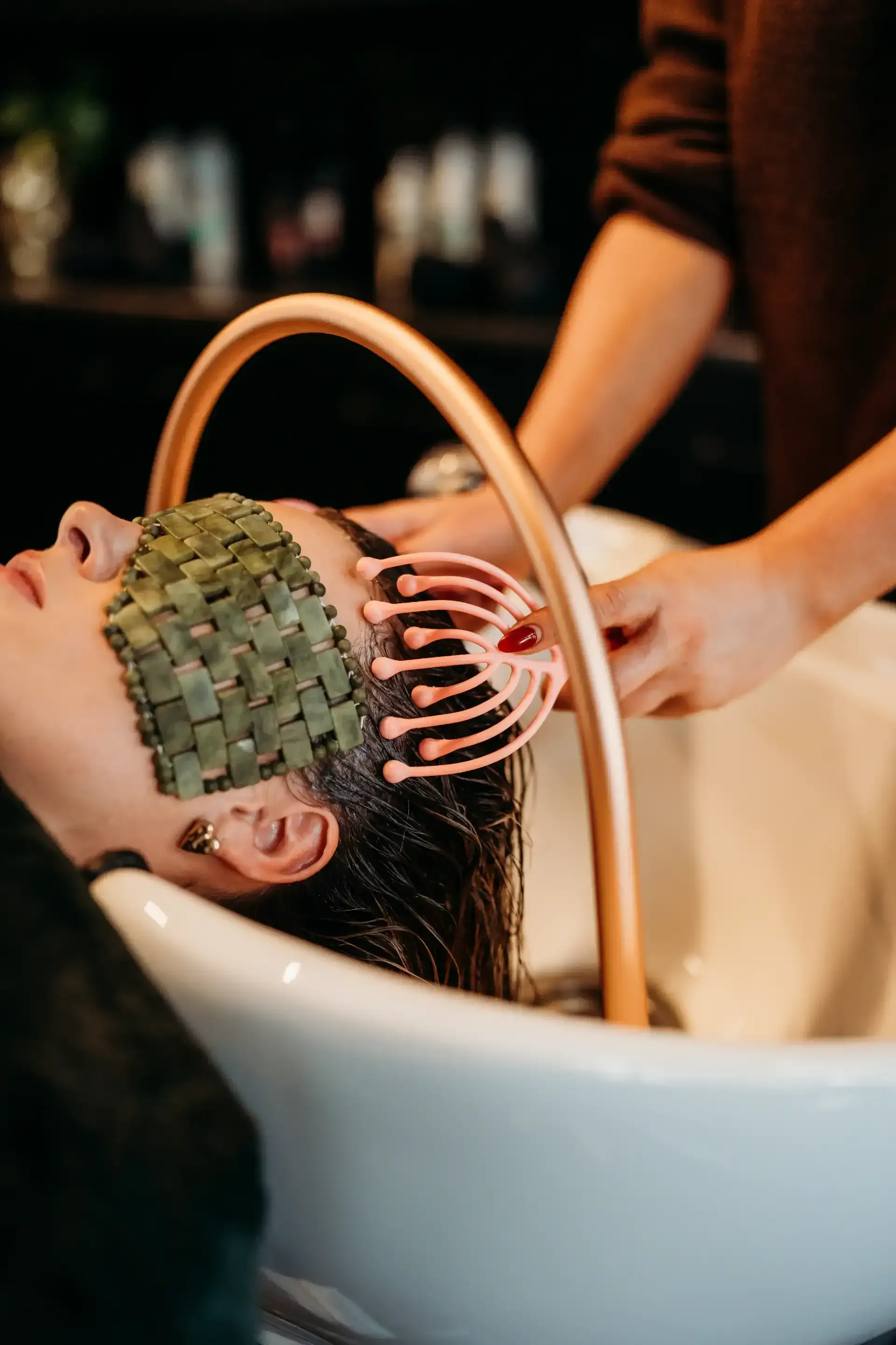 A Woman is Getting Her Hair Washed in a Sink at a Salon — Air Hair Studio in Toowoomba City, QLD