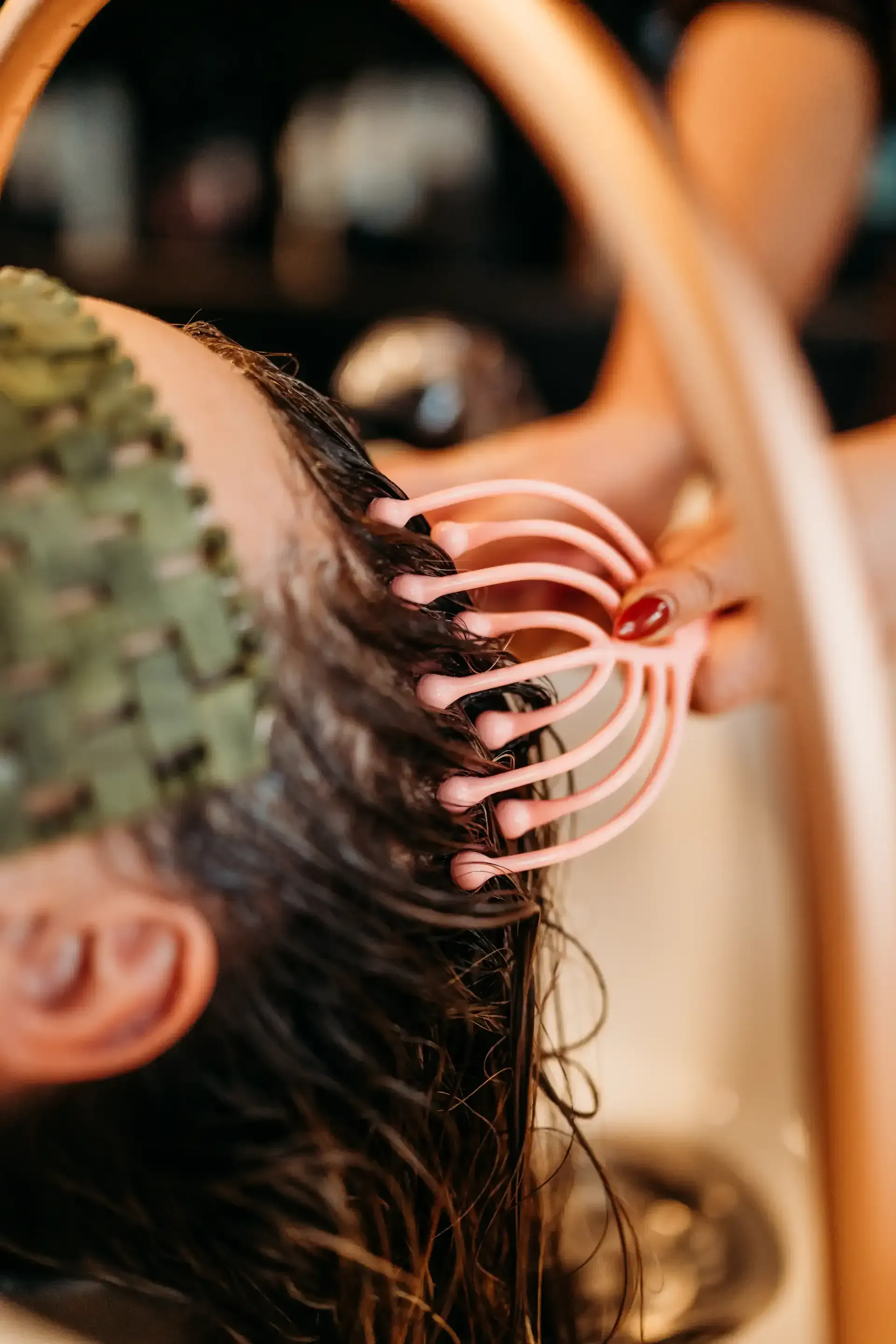 A woman is getting her hair washed at a salon.