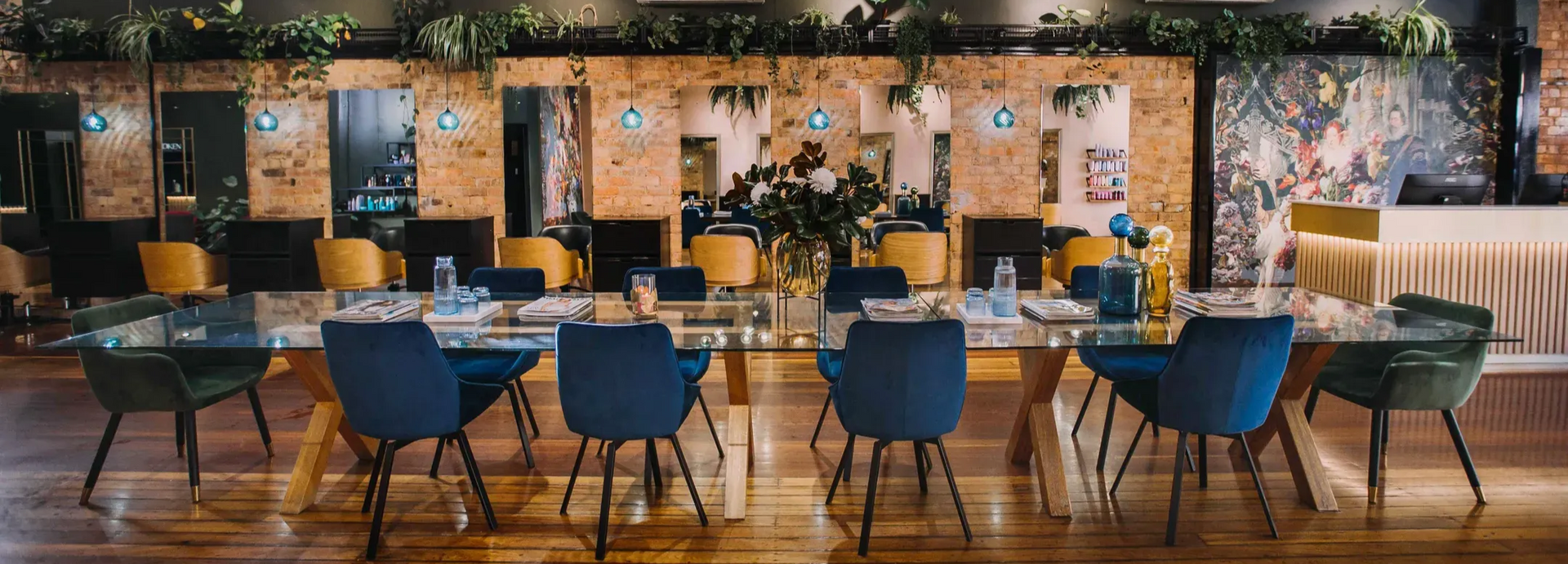 Group of women, hairdressers, in a salon setting. They are wearing black and smiling.