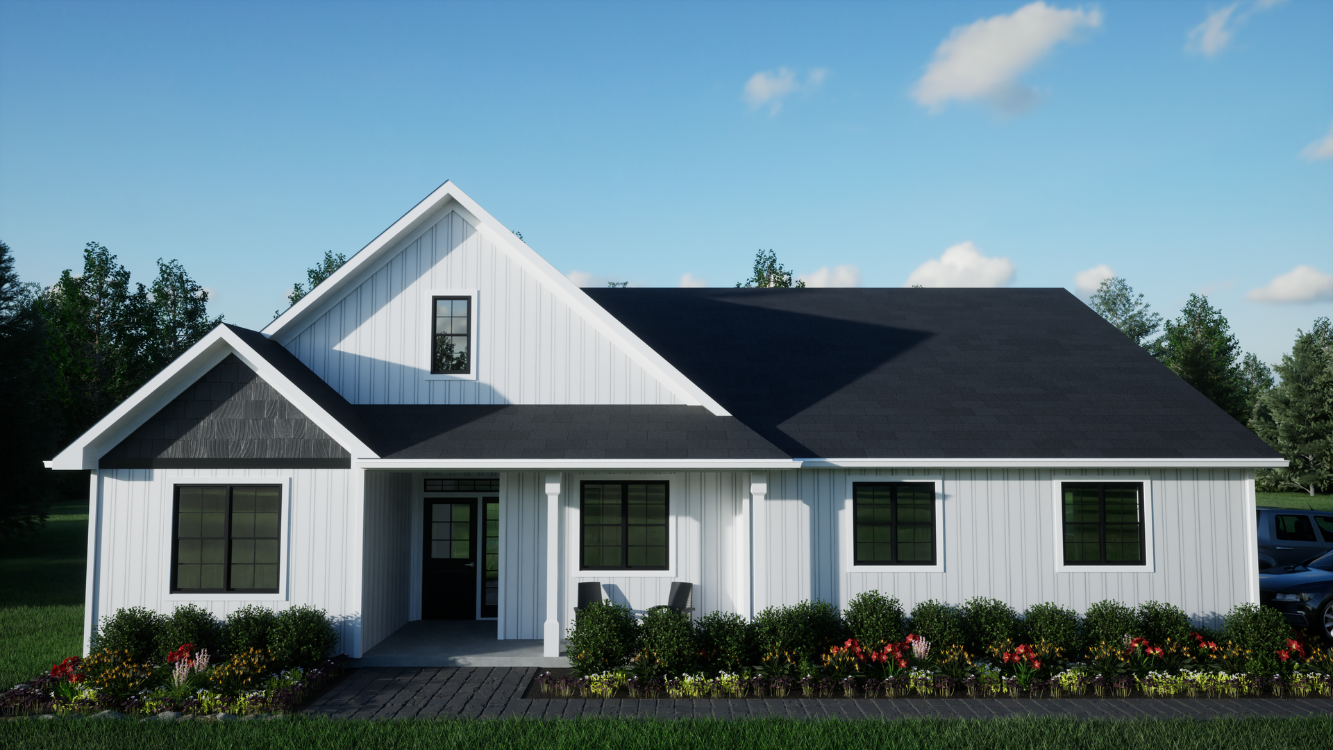 A white house with a black roof is sitting on top of a lush green field.