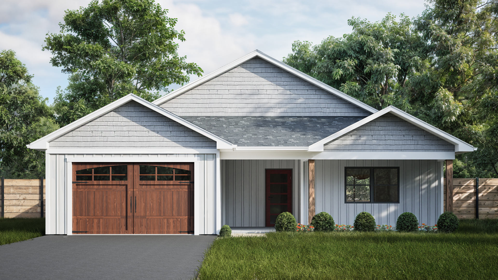 A white house with a brown garage door is surrounded by trees.