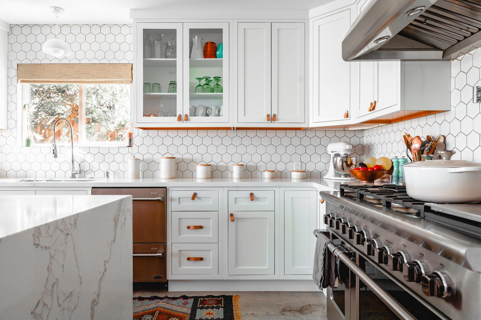 homey kitchen interior with gas stove and white cabinets