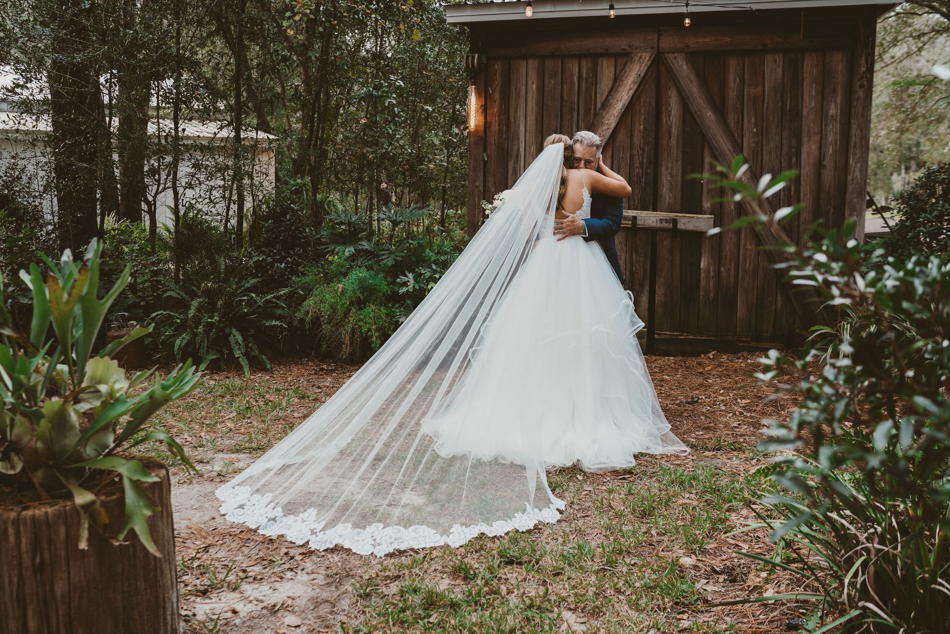 father hugging bride