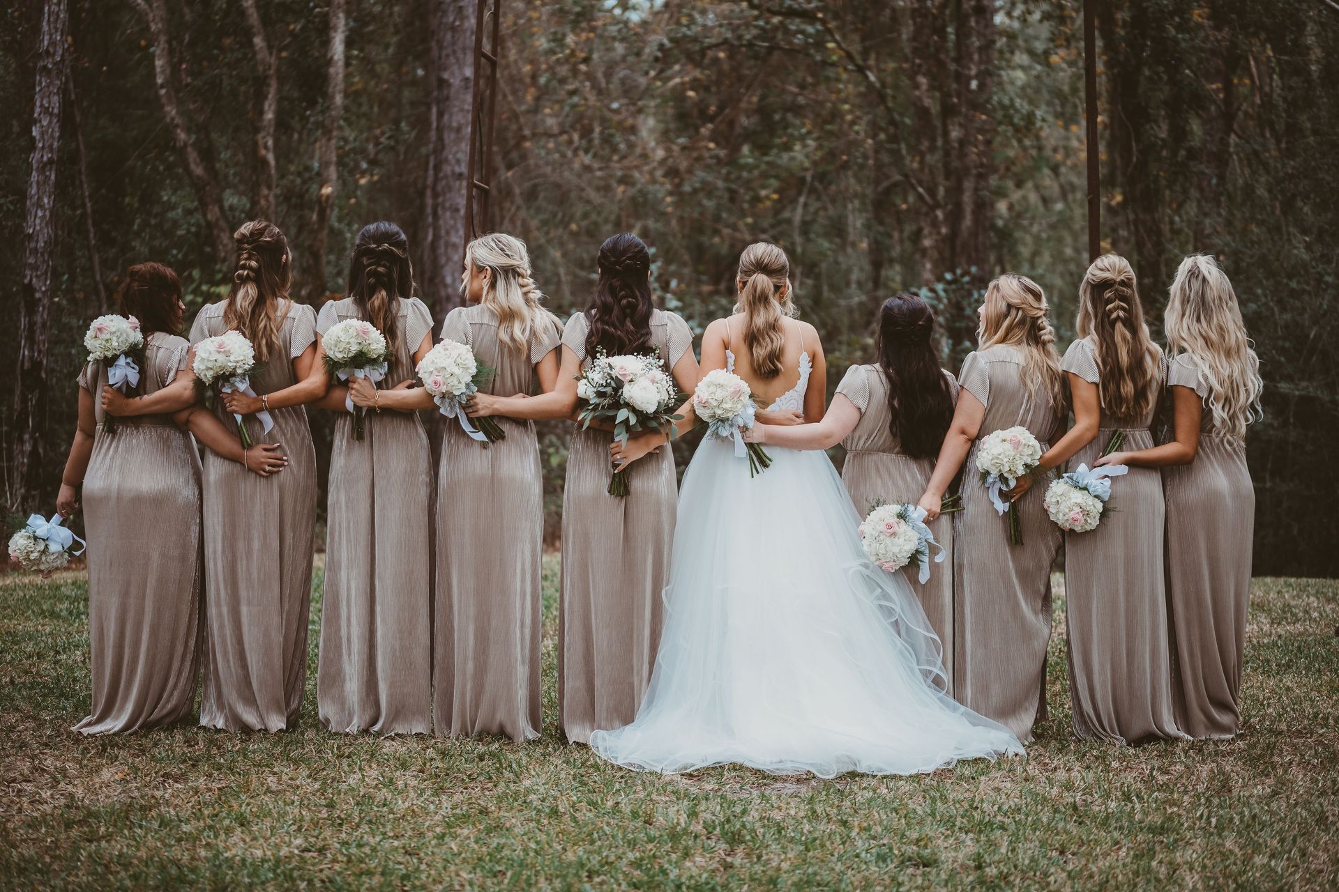 bride embracing bridesmaids