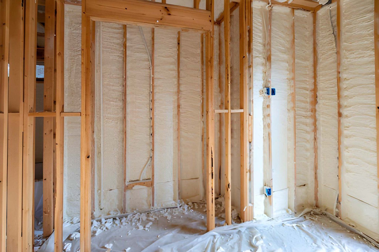 Newly applied spray foam insulation in residential wall cavities.