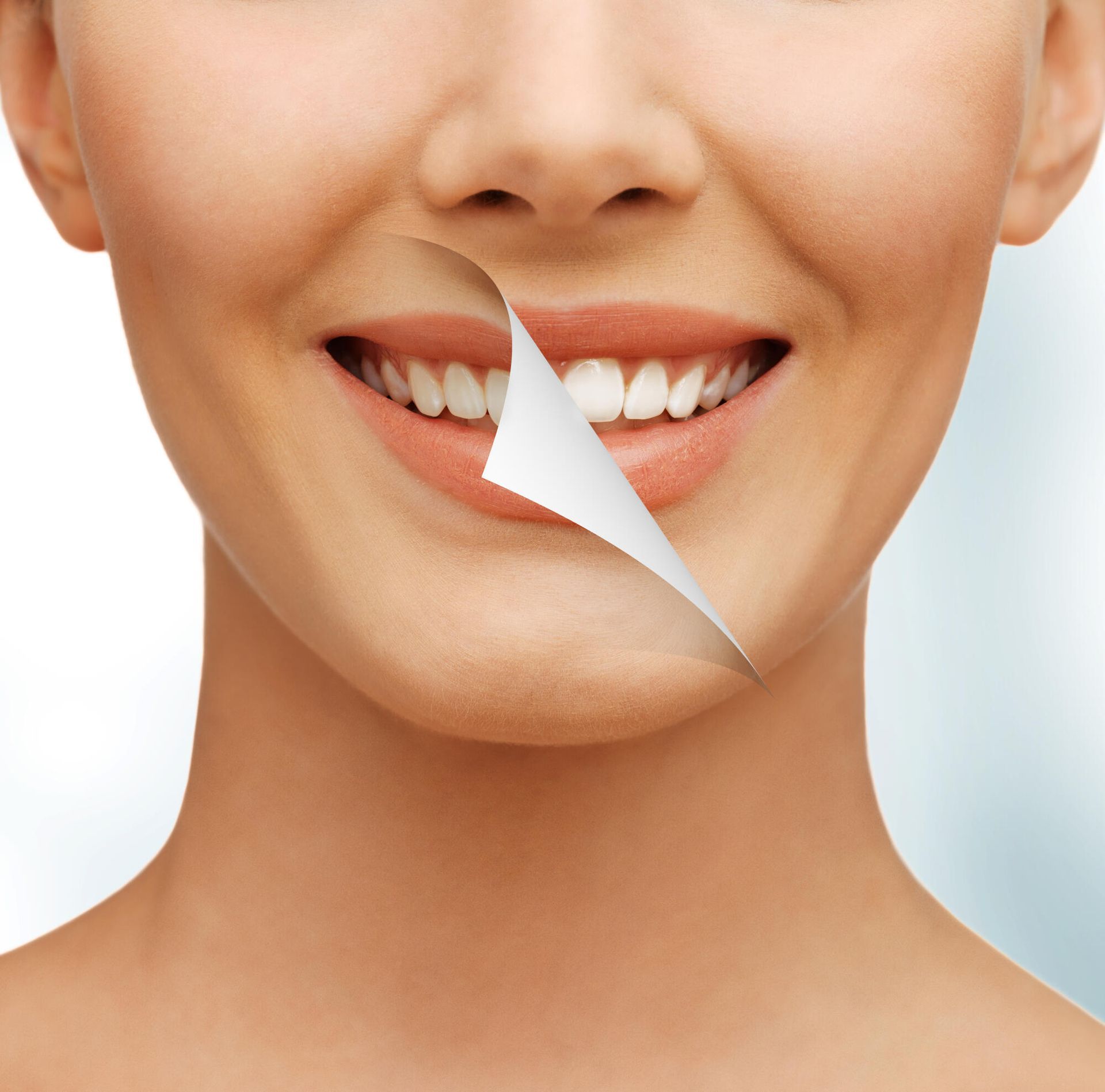 A close up of a woman 's face with a piece of paper missing