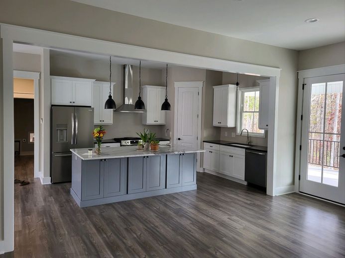 A kitchen with a large island in the middle of the room.