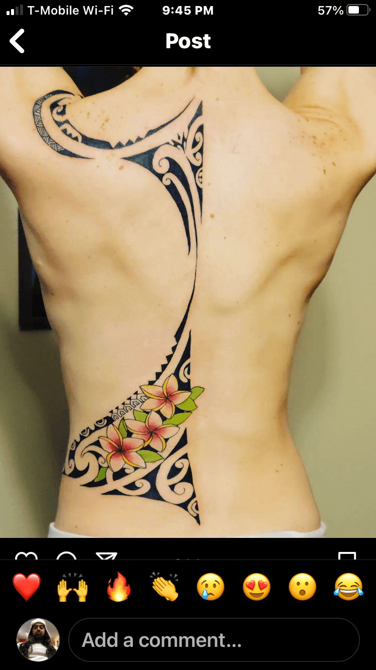 A picture of a woman 's back with a tattoo on it