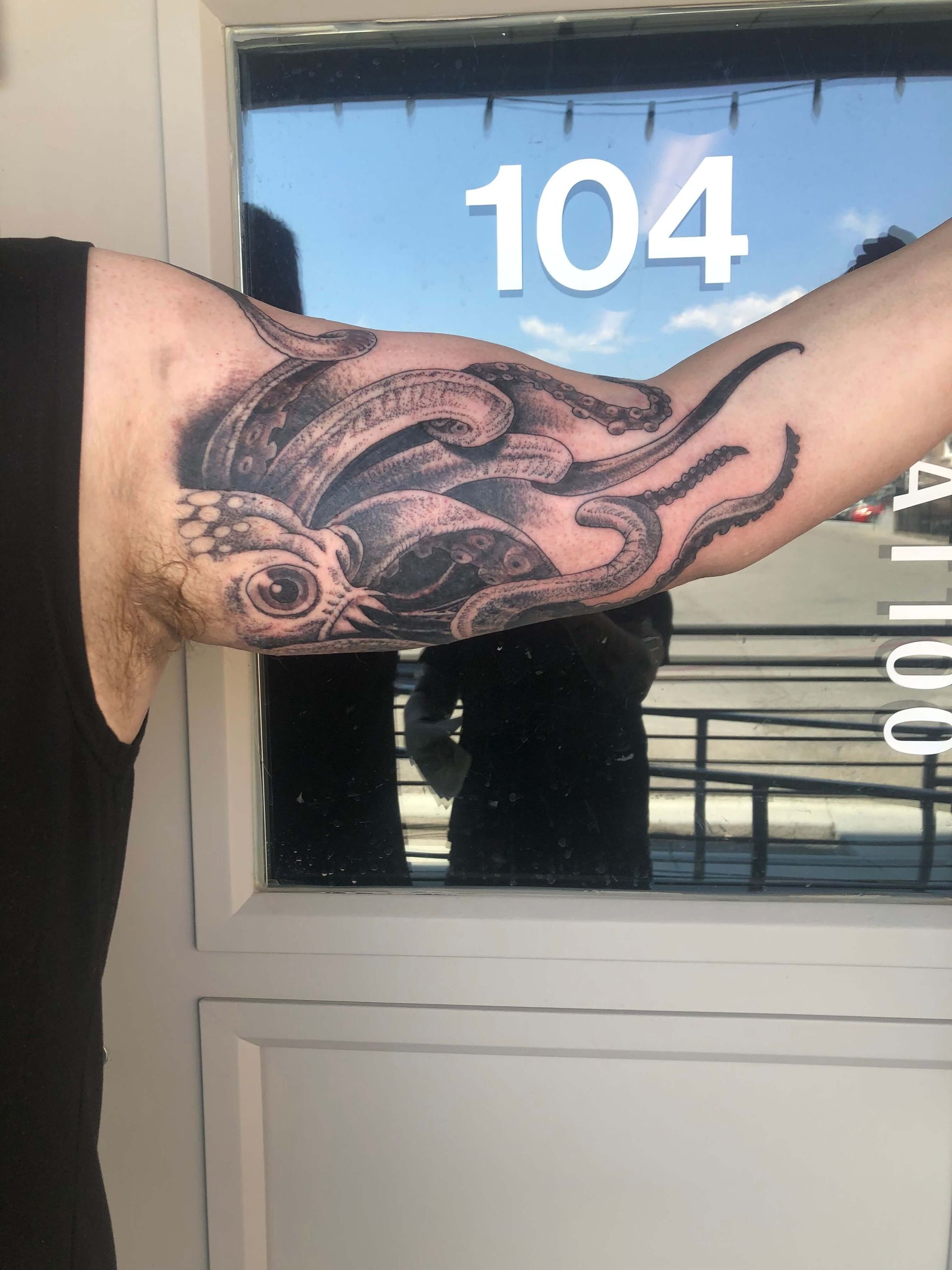 A man has a tattoo of an octopus on his arm
