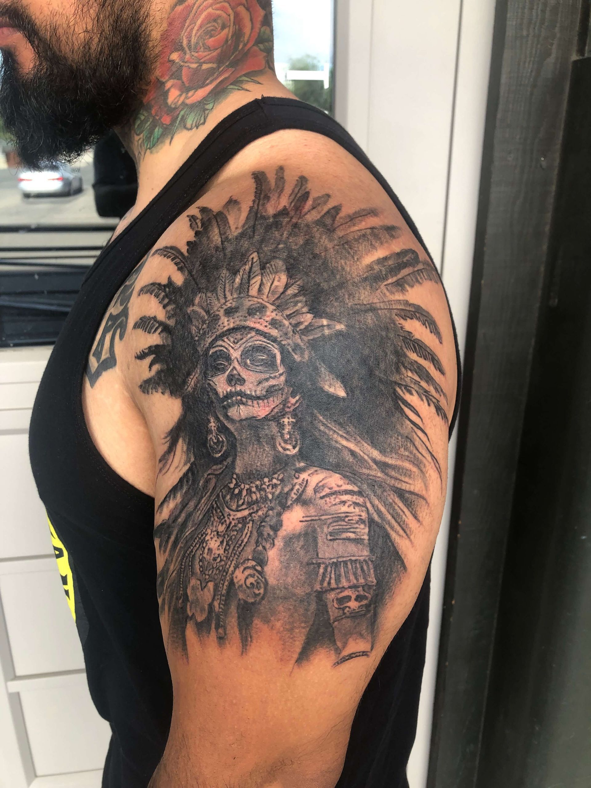 A man has a tattoo of a native american on his arm