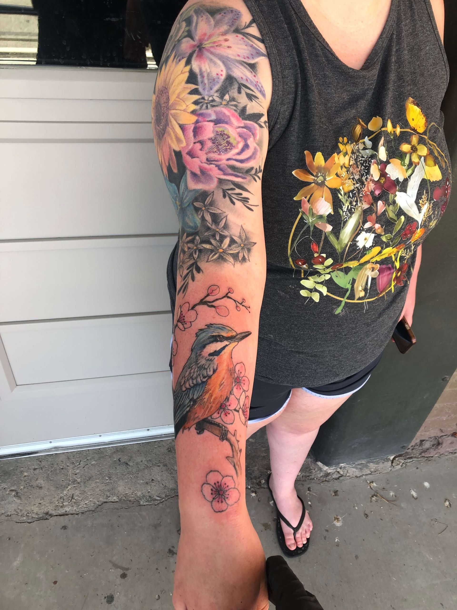 A woman with a floral tattoo on her arm