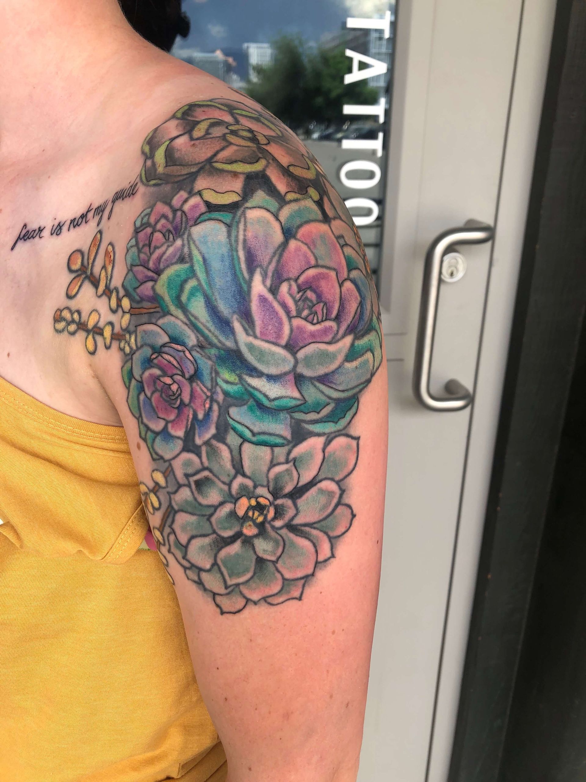 A woman has a tattoo of succulents on her arm