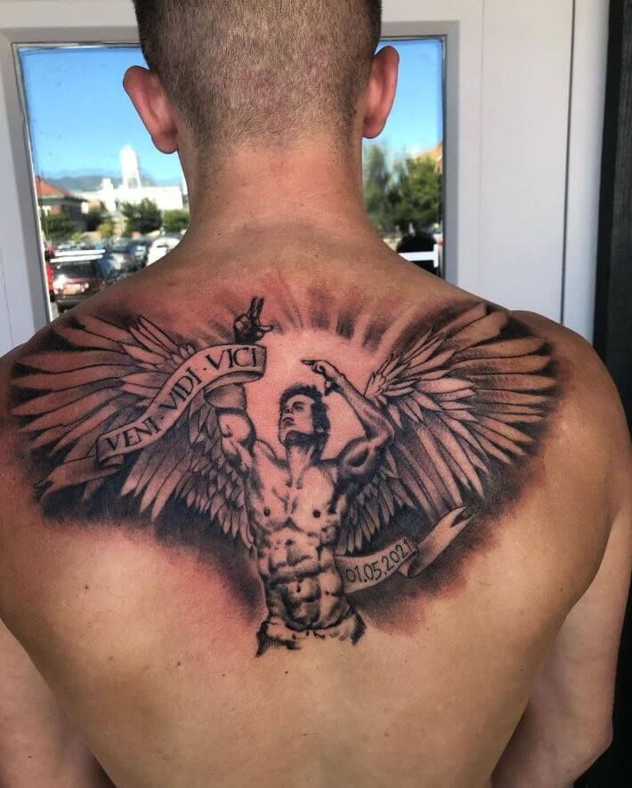 A man has a tattoo on his back that says 