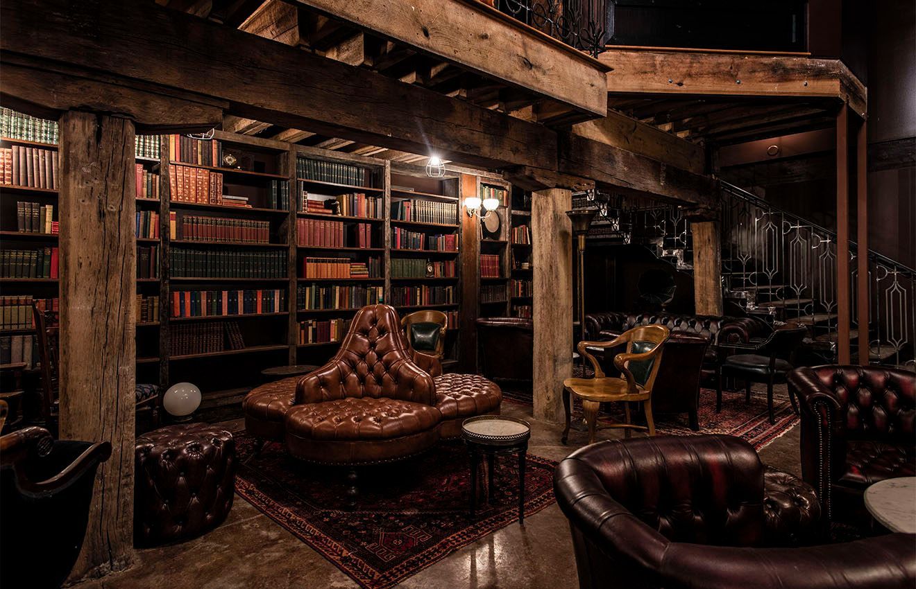 A living room filled with furniture and bookshelves.