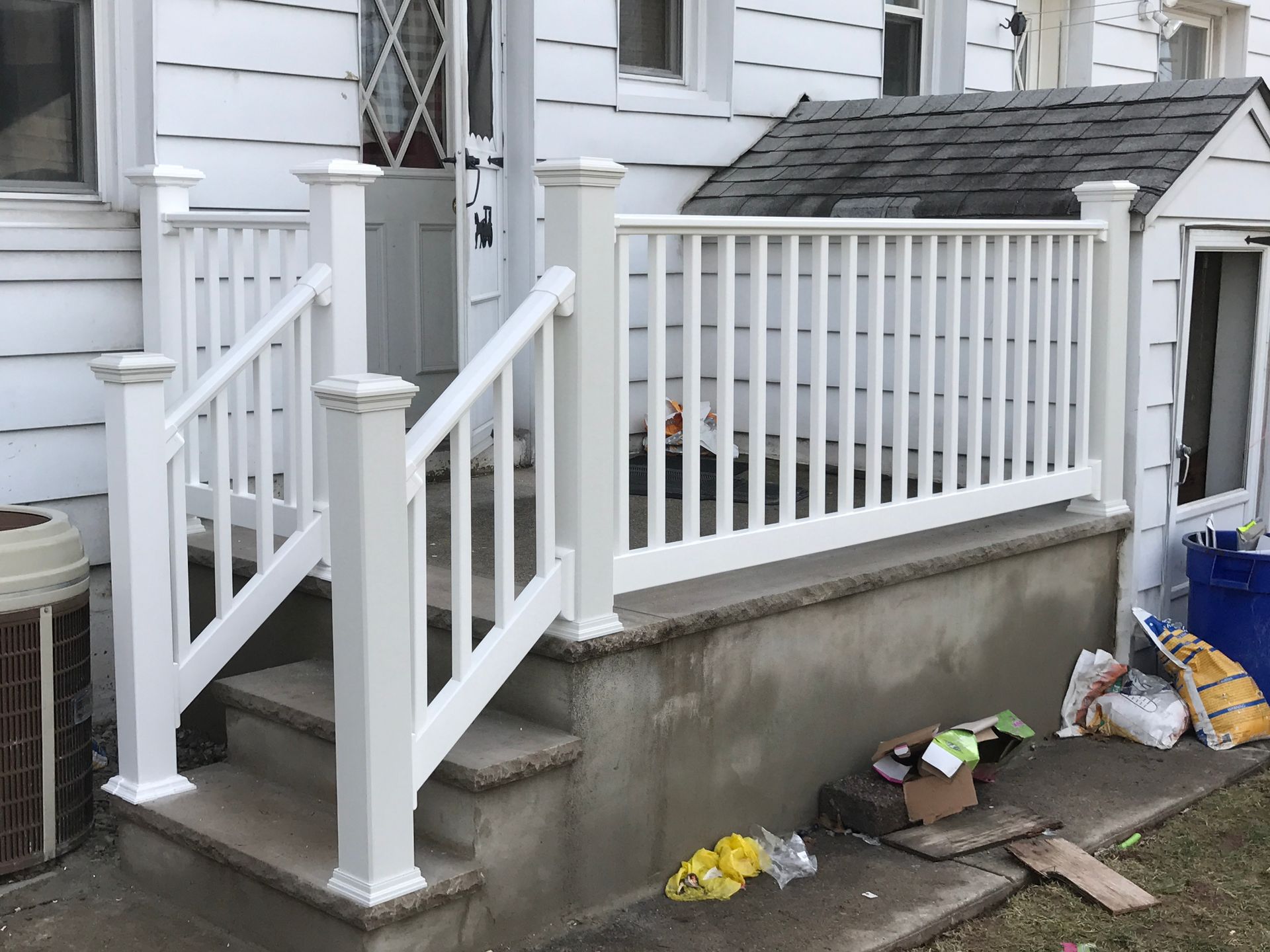 A man wearing a hard hat is standing in a bathroom.