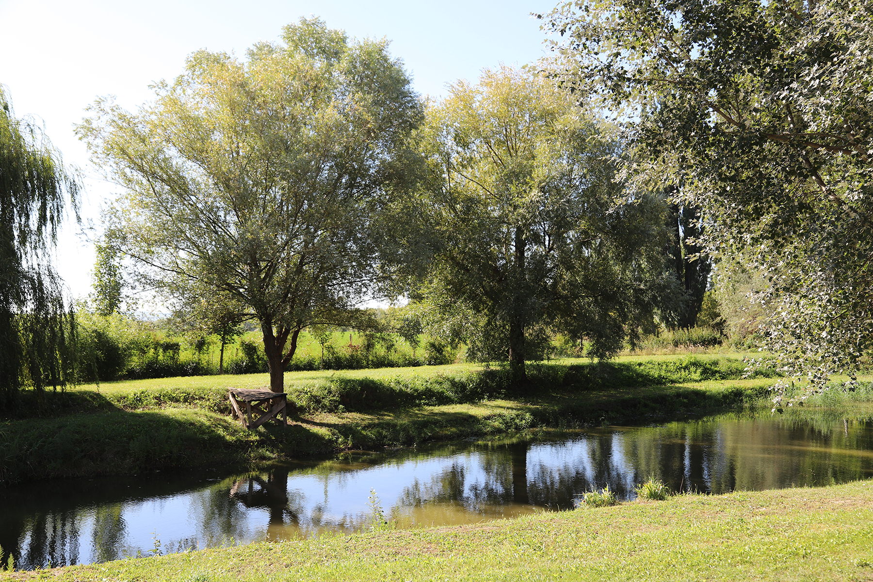 Two men in suits are shaking hands in front of a building.