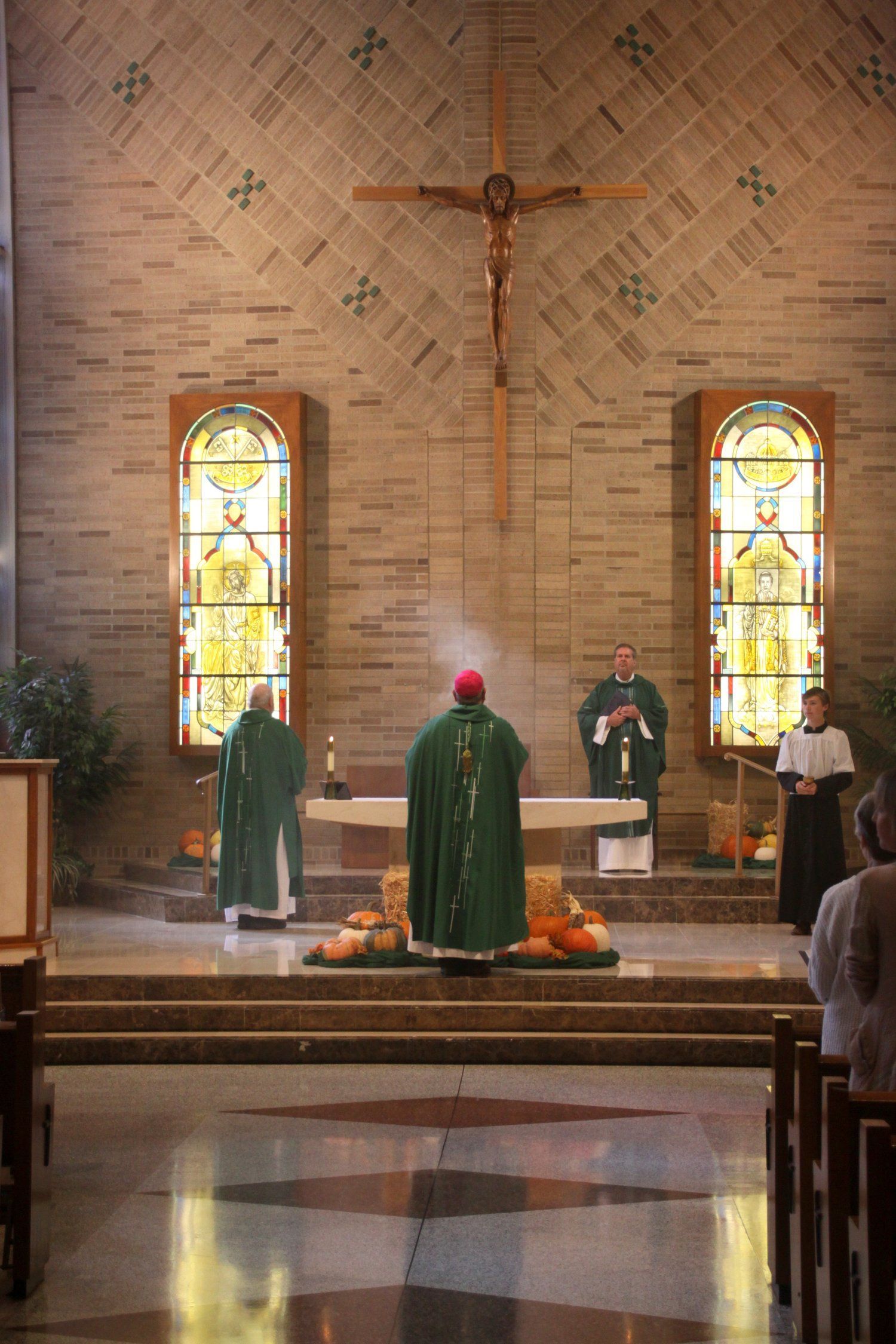 the priest is in front of the altar
