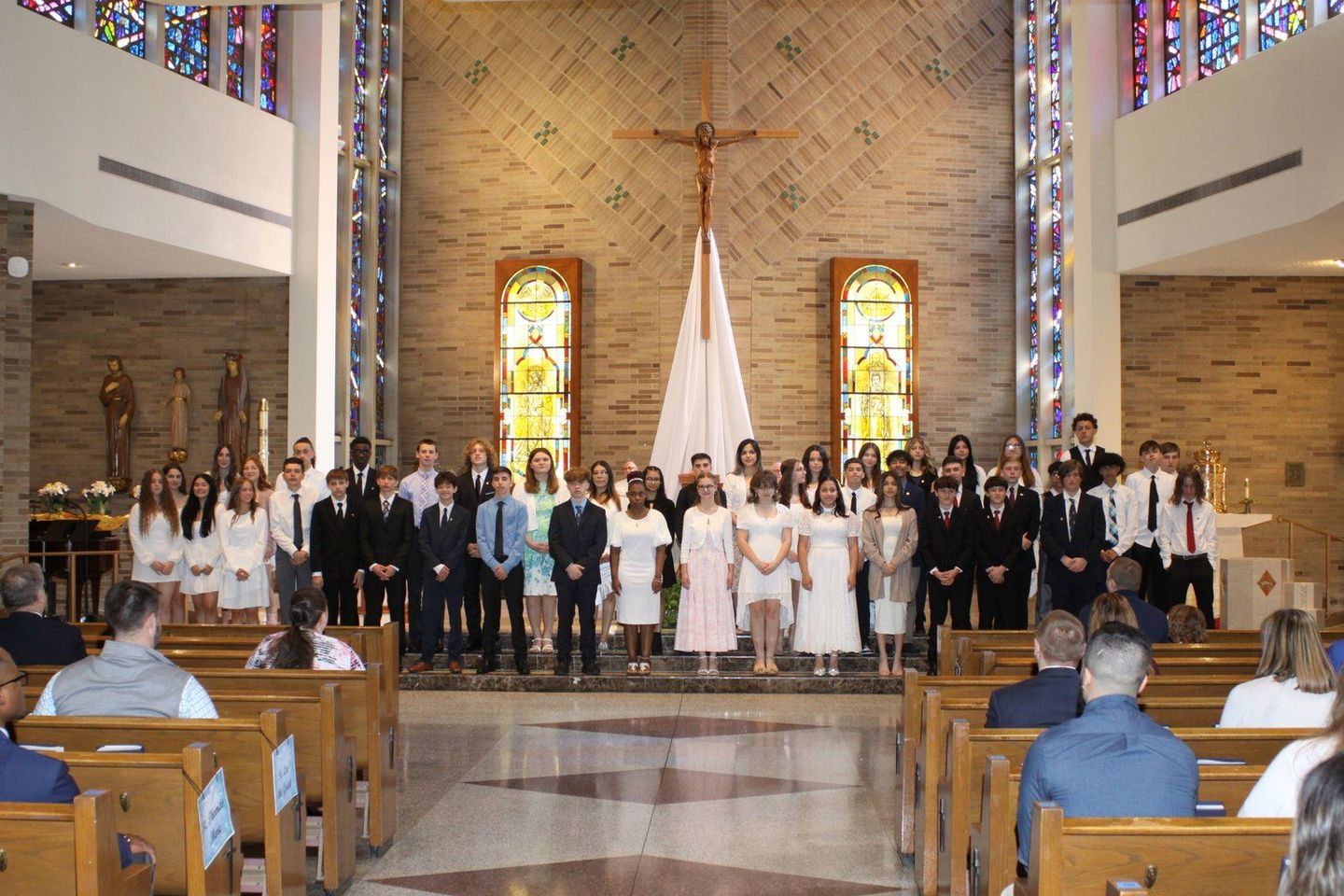 A group of people are standing in front of the church altar