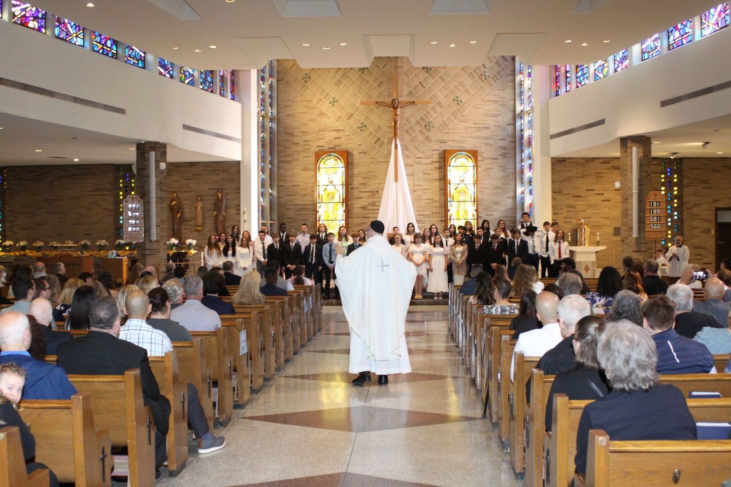 the bishop is walking towards the altar