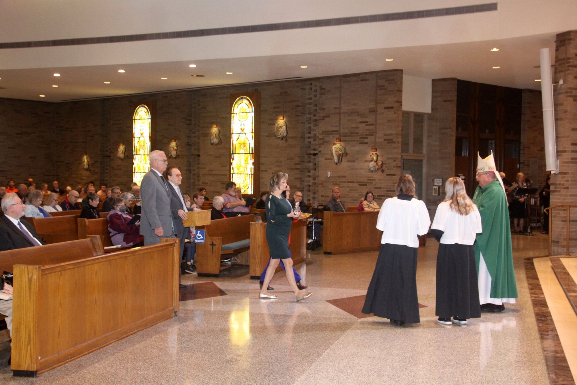 A group of people are standing in a church.