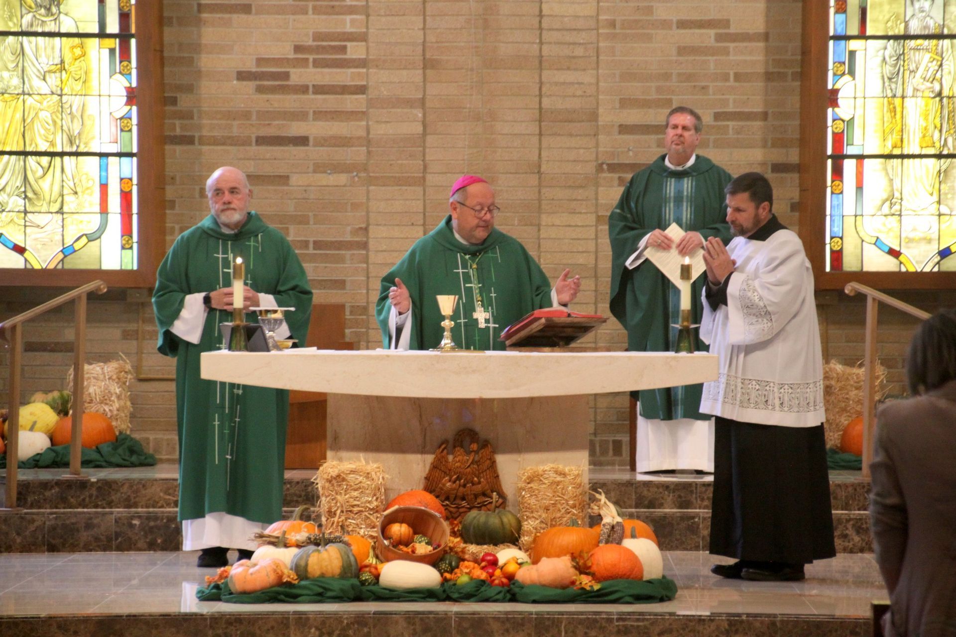 A group of priests are standing around an altar in a church.