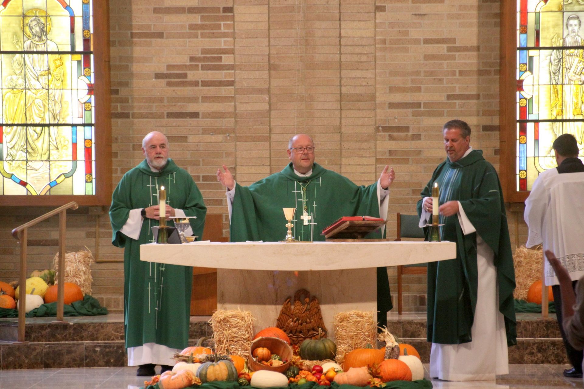 A group of priests are standing around an altar in a church.